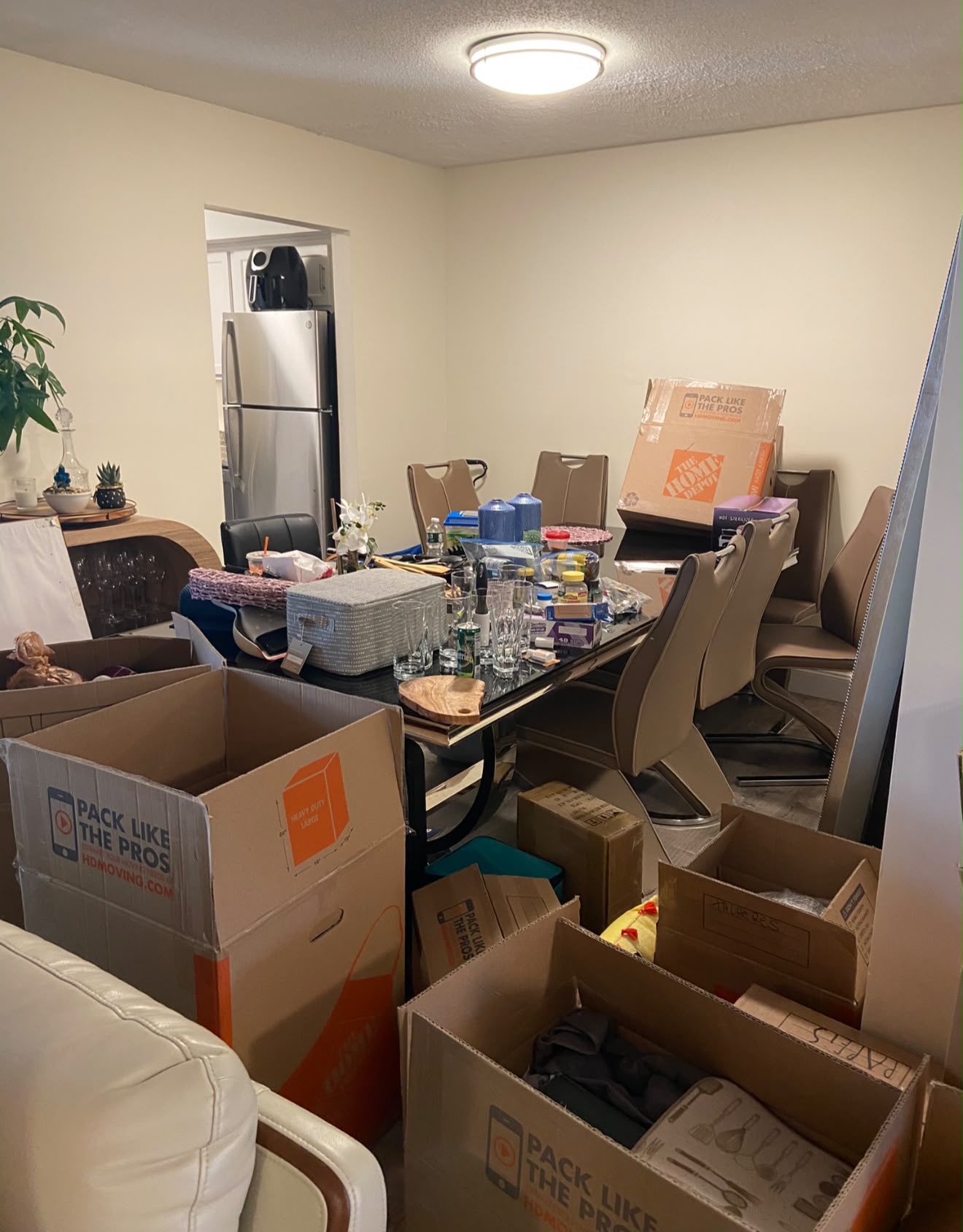 Dining room before move-out, full of moving boxes